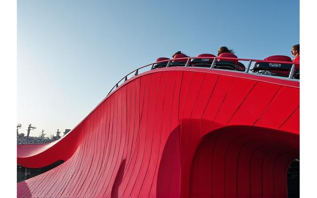 Red Ferrari World roller coaster structure against blue sky